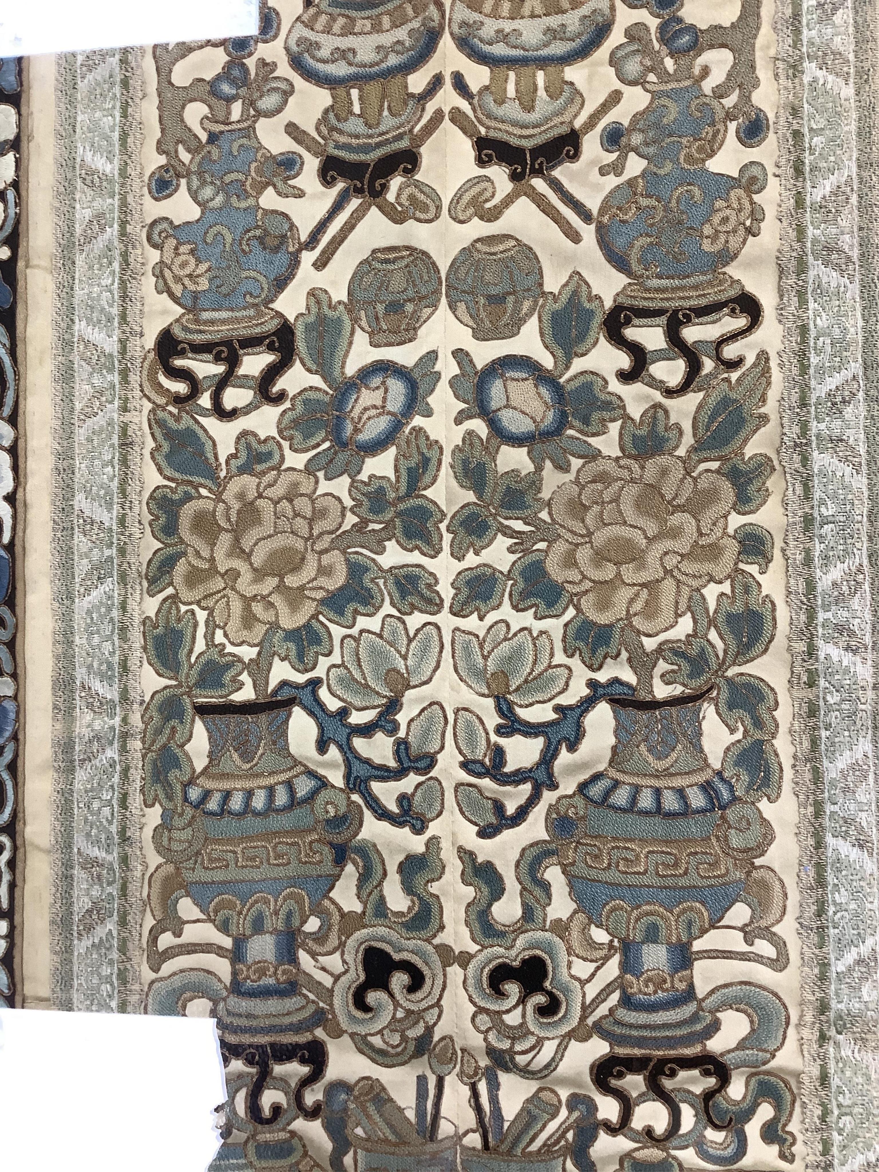 Two pairs of 19th century Chinese, Peking knot, silk embroidered sleeve bands. Worked on cream silk. Both embroidered mostly in blues and gilt thread, in flower, bird and auspicious motifs, both bordered with black silk